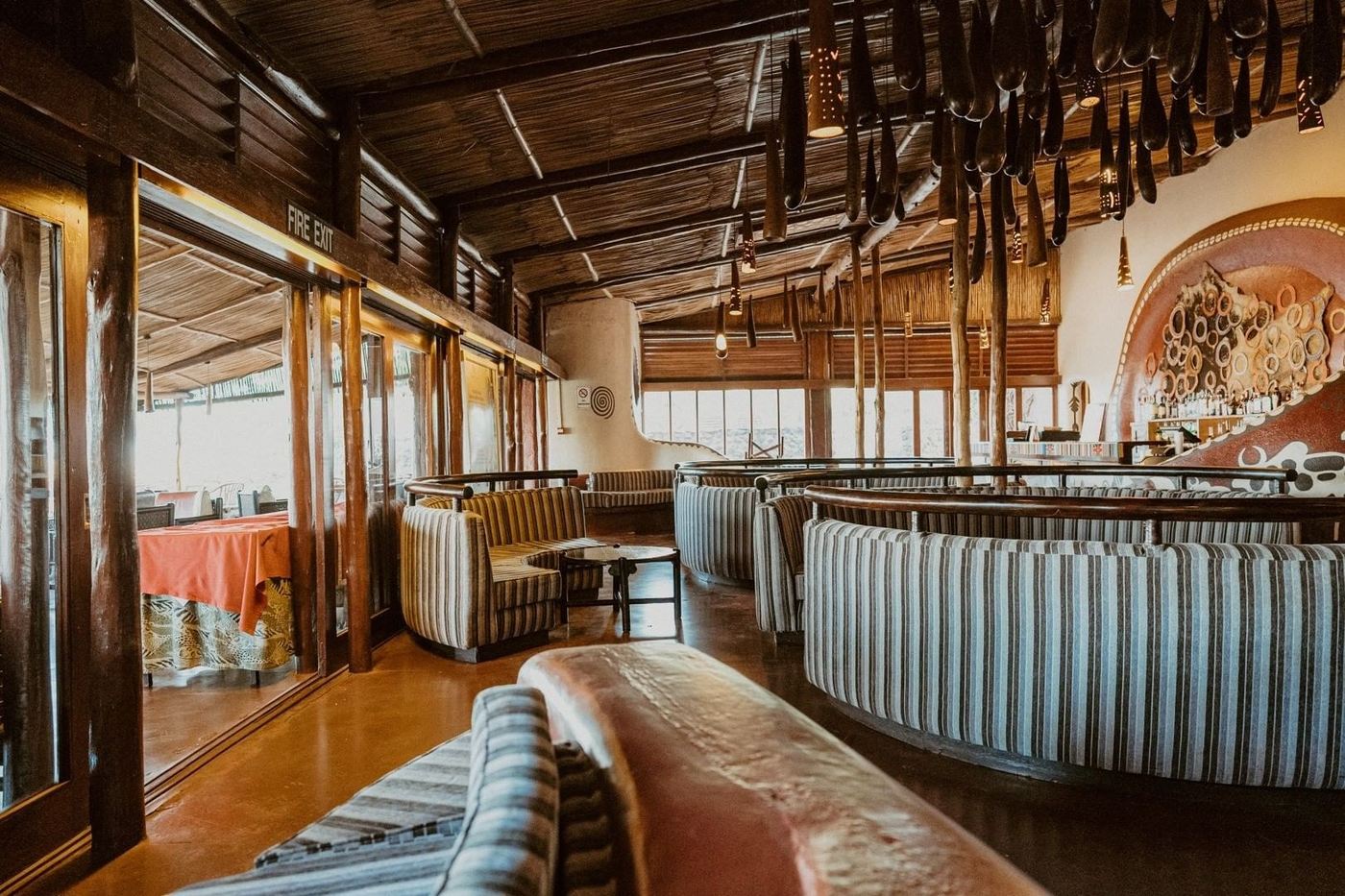 Arched lounge interior with sofas and warm lighting at Amboseli Serena Safari Lodge.