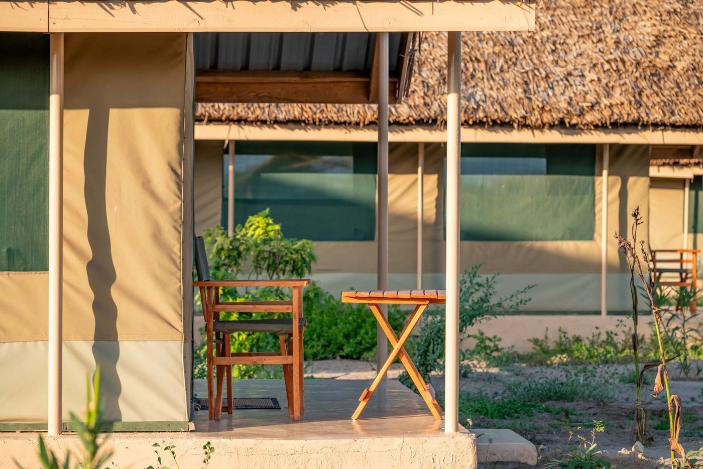 Private veranda with table and chairs outside a tented room at Amboseli Wildebeest Camp.