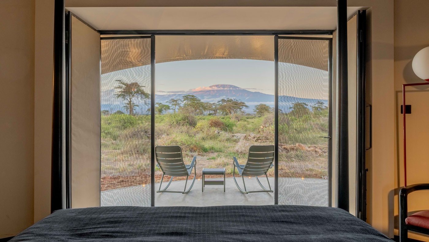 Kilimanjaro framed through the glass doors of a suite at Angama Amboseli.