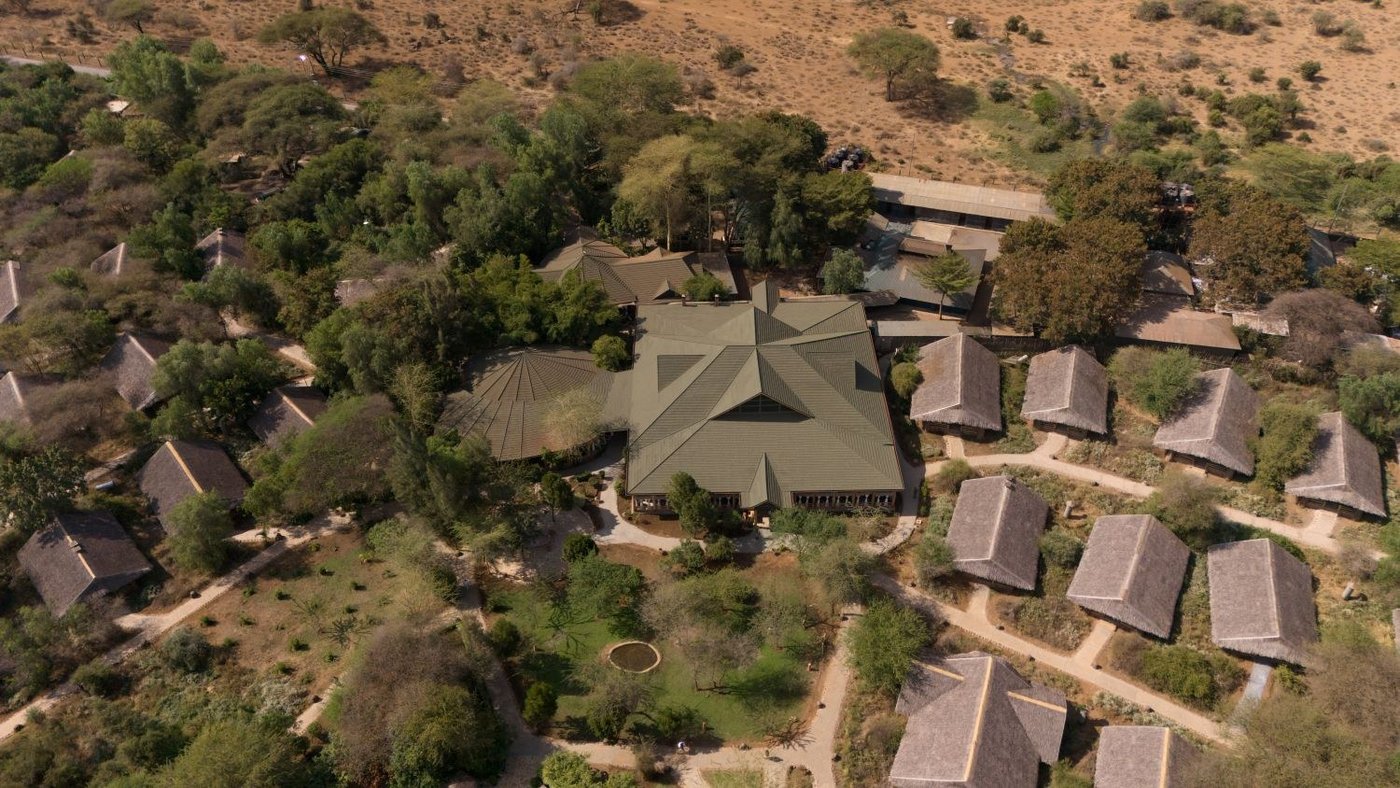 Aerial view of the tented camp laid out among green trees at Kibo Safari Camp.