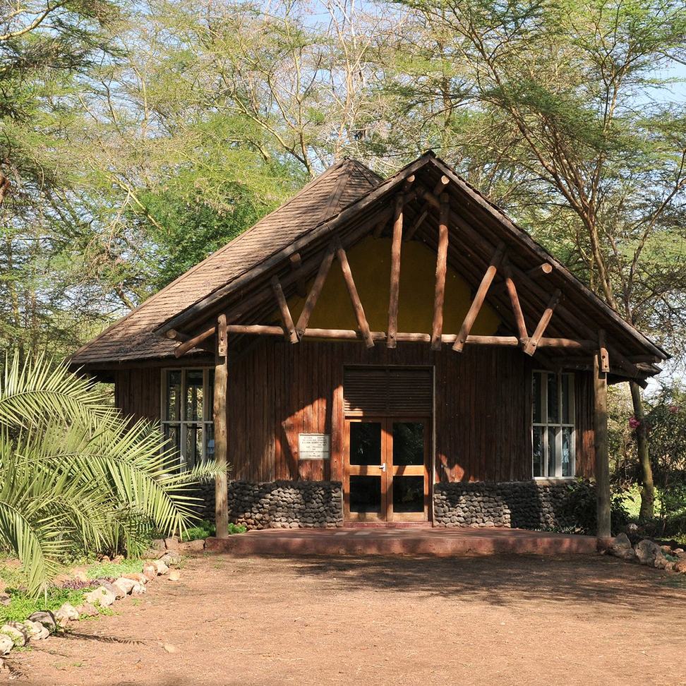 Small thatched-roof building on the grounds of Ol Tukai Lodge.