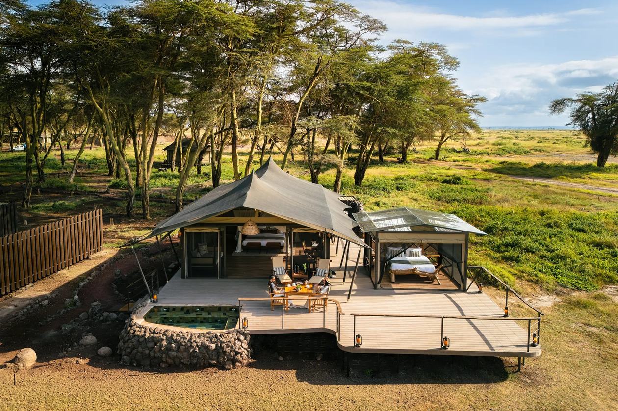 Aerial view of the tented suite and still pool reflecting the trees at Soroi Amboseli.