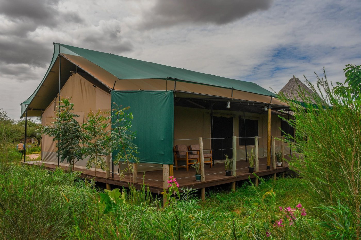 Green-roofed guest tent with a private deck at Sungura Safari Camp.